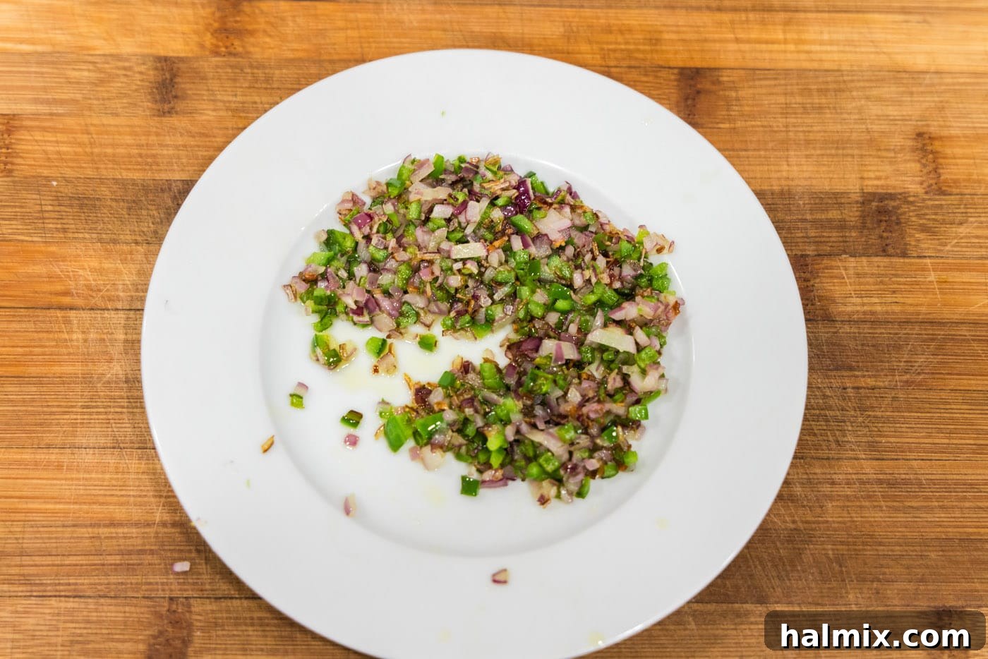 Mighty Buffalo Burger 6 Perfectly sautéed onions and jalapenos, tender and slightly browned, resting on a plate after being removed from the skillet.