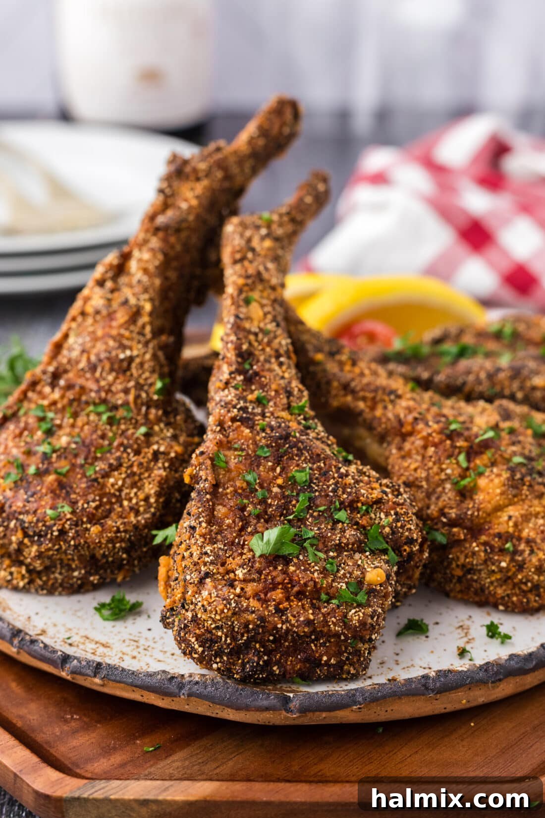 Golden Fried Lamb Perfection 3 Fried Lamb Chops stacked together on a plate