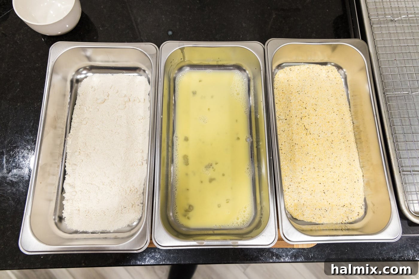 Golden Fried Lamb Perfection 6 dredging station with flour, egg mixture, and cornmeal mixture