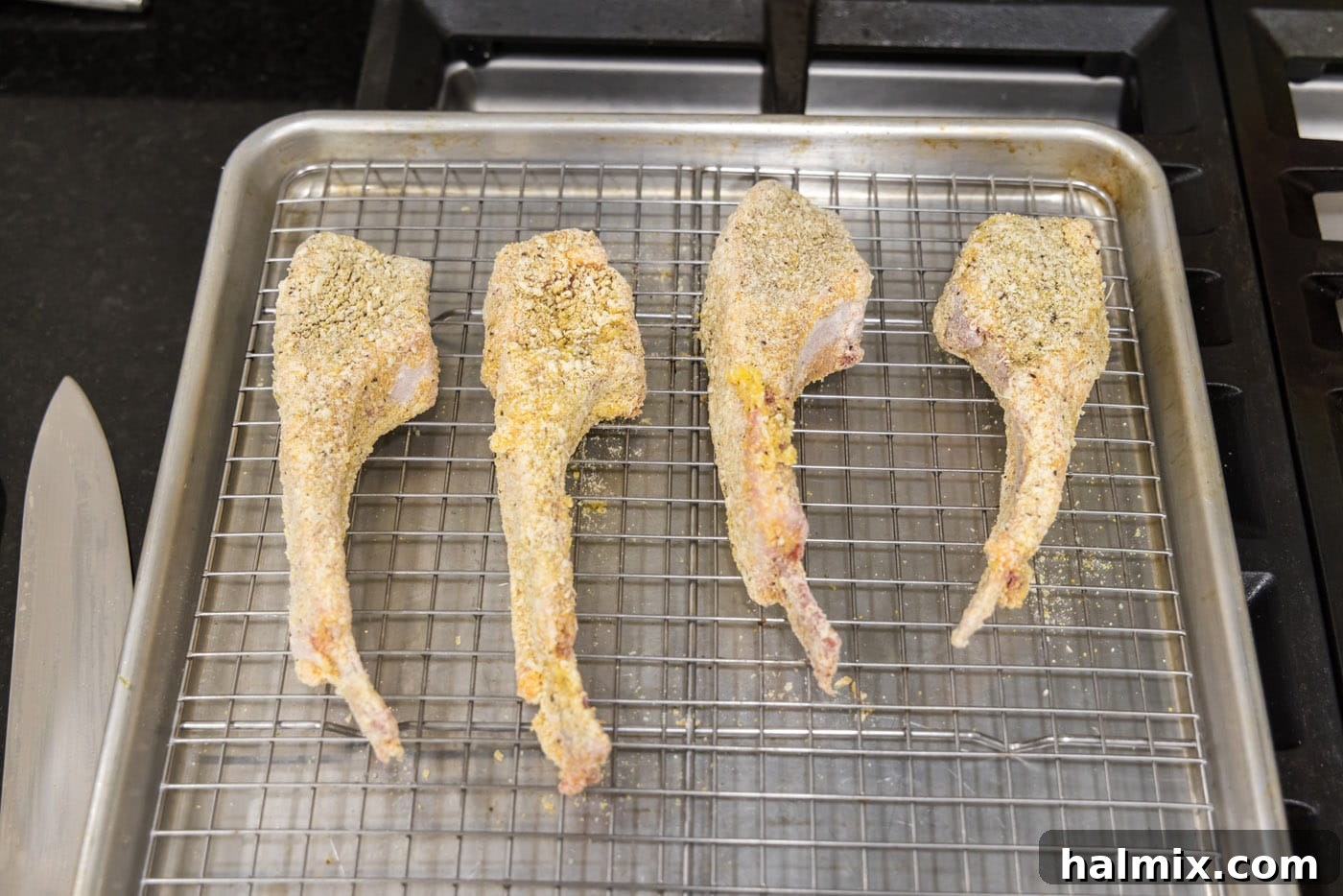 Golden Fried Lamb Perfection 10 dredged lamb chops on a wire rack