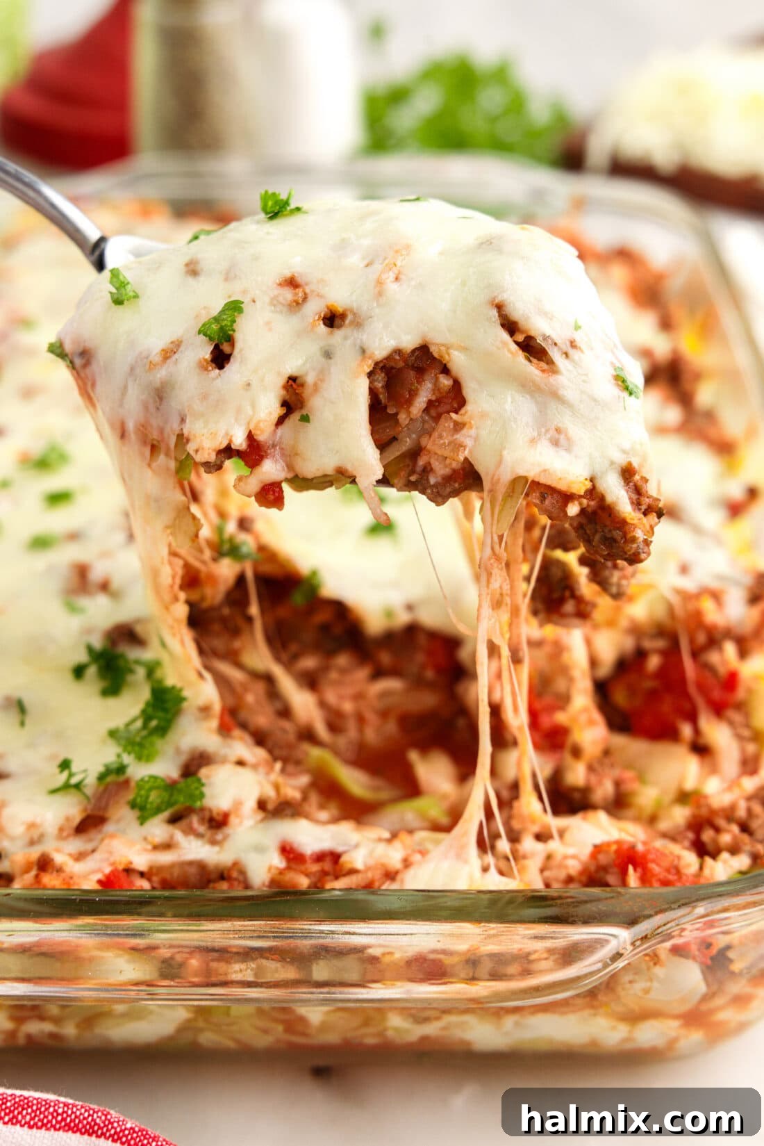 Hearty Unstuffed Cabbage Casserole 2 Scoop of Cabbage Roll Casserole being lifted out of the dish