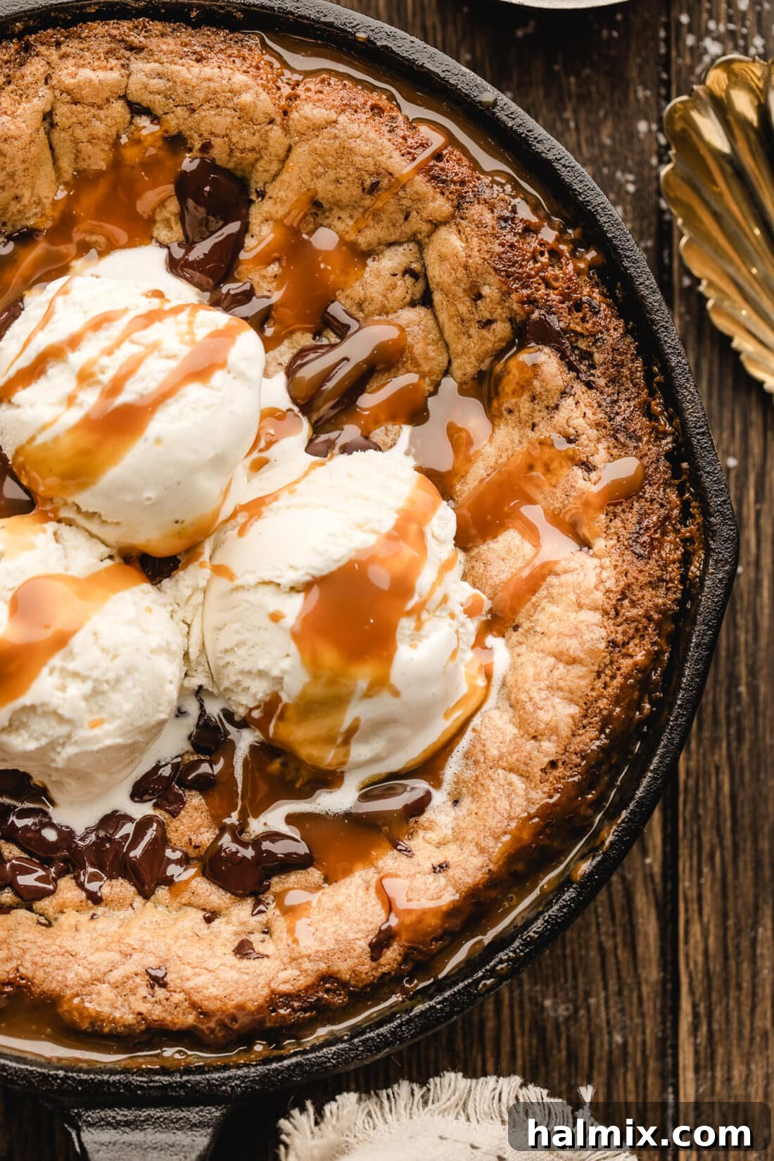 Decadent Caramel Chocolate Skillet 2 Close up photo of a slice of Chocolate Chip Caramel Skillet Cookie, revealing layers of gooey caramel and melted chocolate.