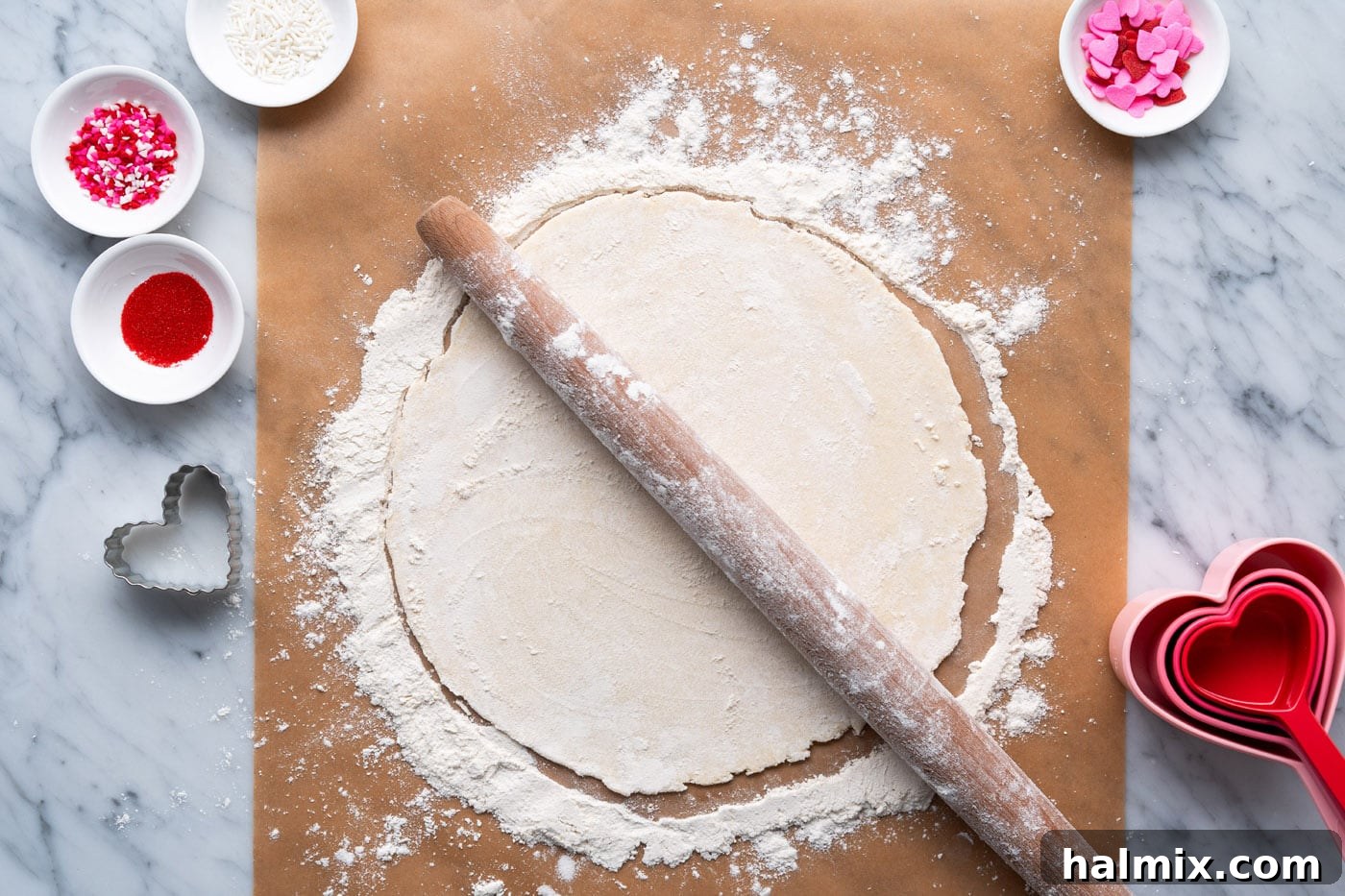 rolling pin on top of flattened pie dough