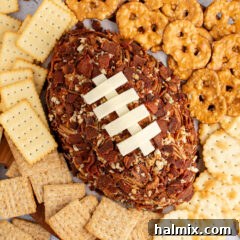 Close up photo of a Football Cheese Ball with crackers around it