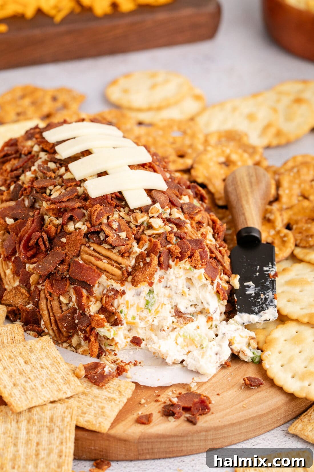 Football Cheese Ball on a platter with some removed 