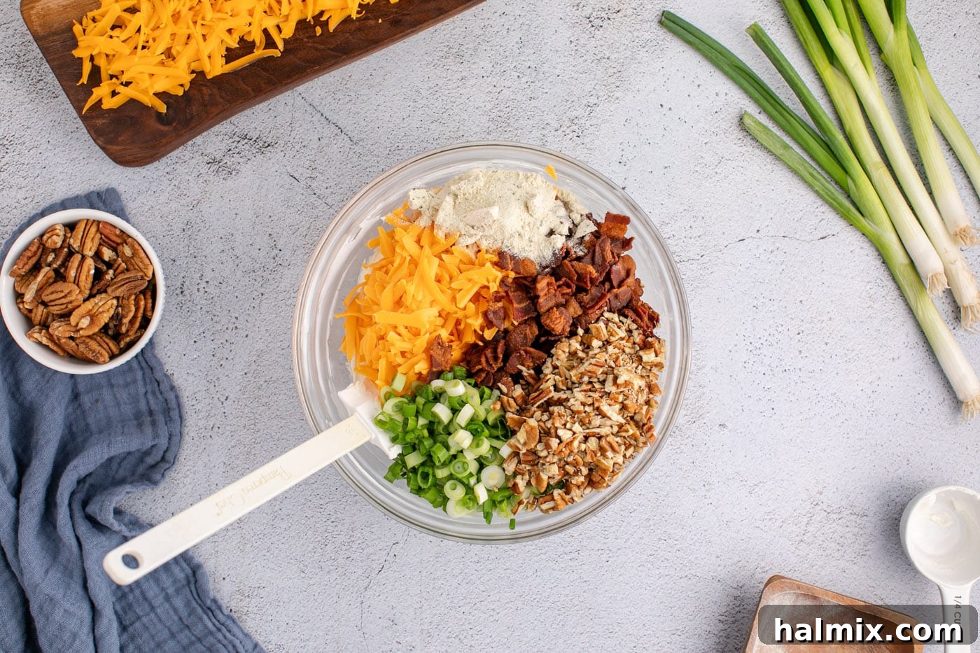 cheddar cheese, pecans, bacon, green onions, and cream cheese mixture in a bowl
