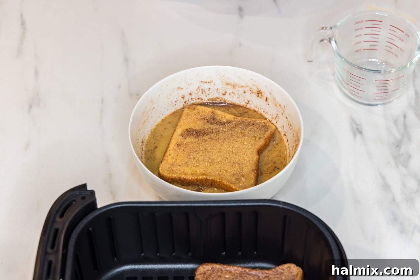 coating bread slice in egg mixture