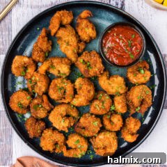 Breaded Shrimp on a plate with a bowl of cocktail sauce