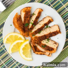 Overhead photo of a Korean Fish Cake sliced on a plate with lemon slices