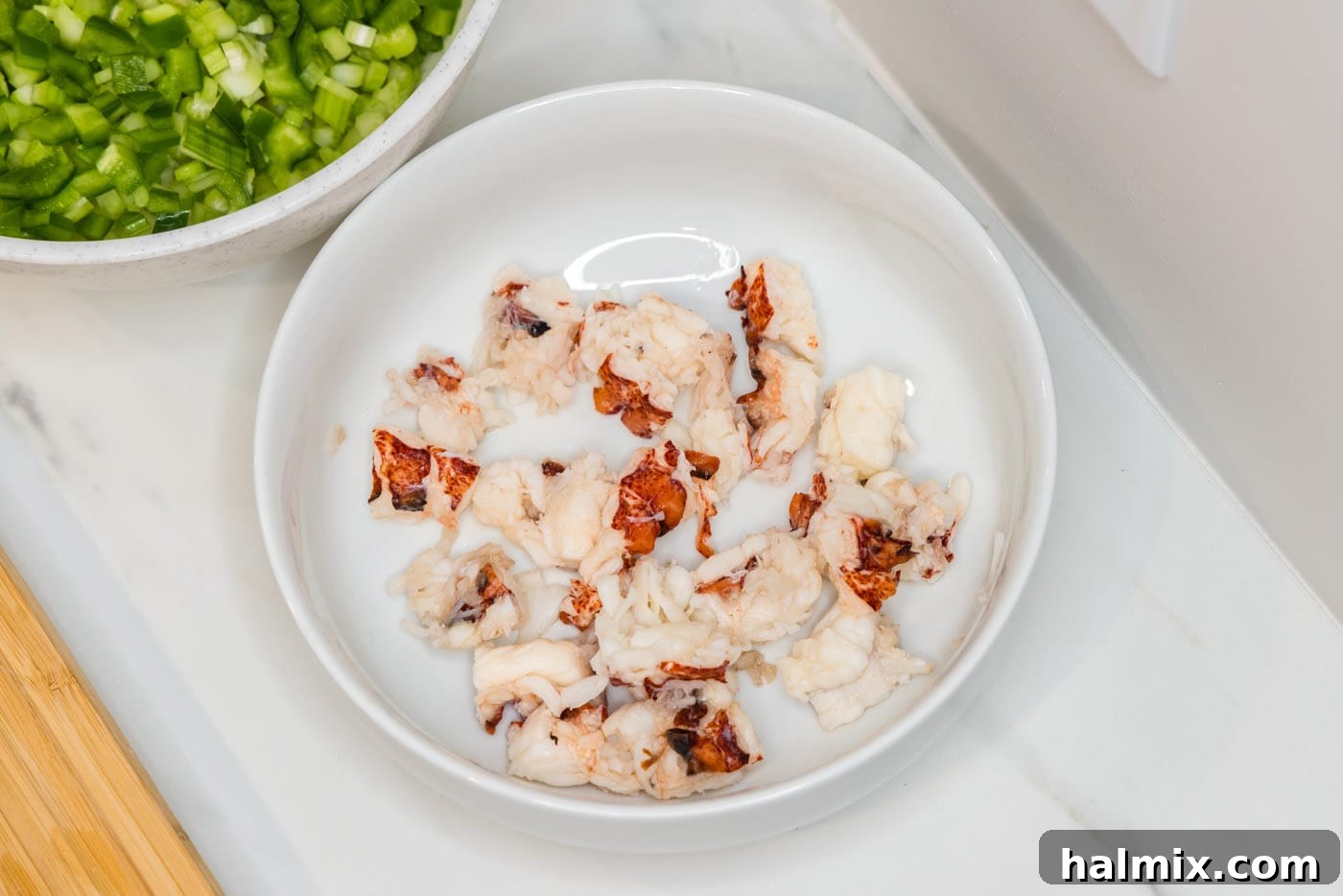 Bowl filled with bite-sized chunks of cooked lobster meat
