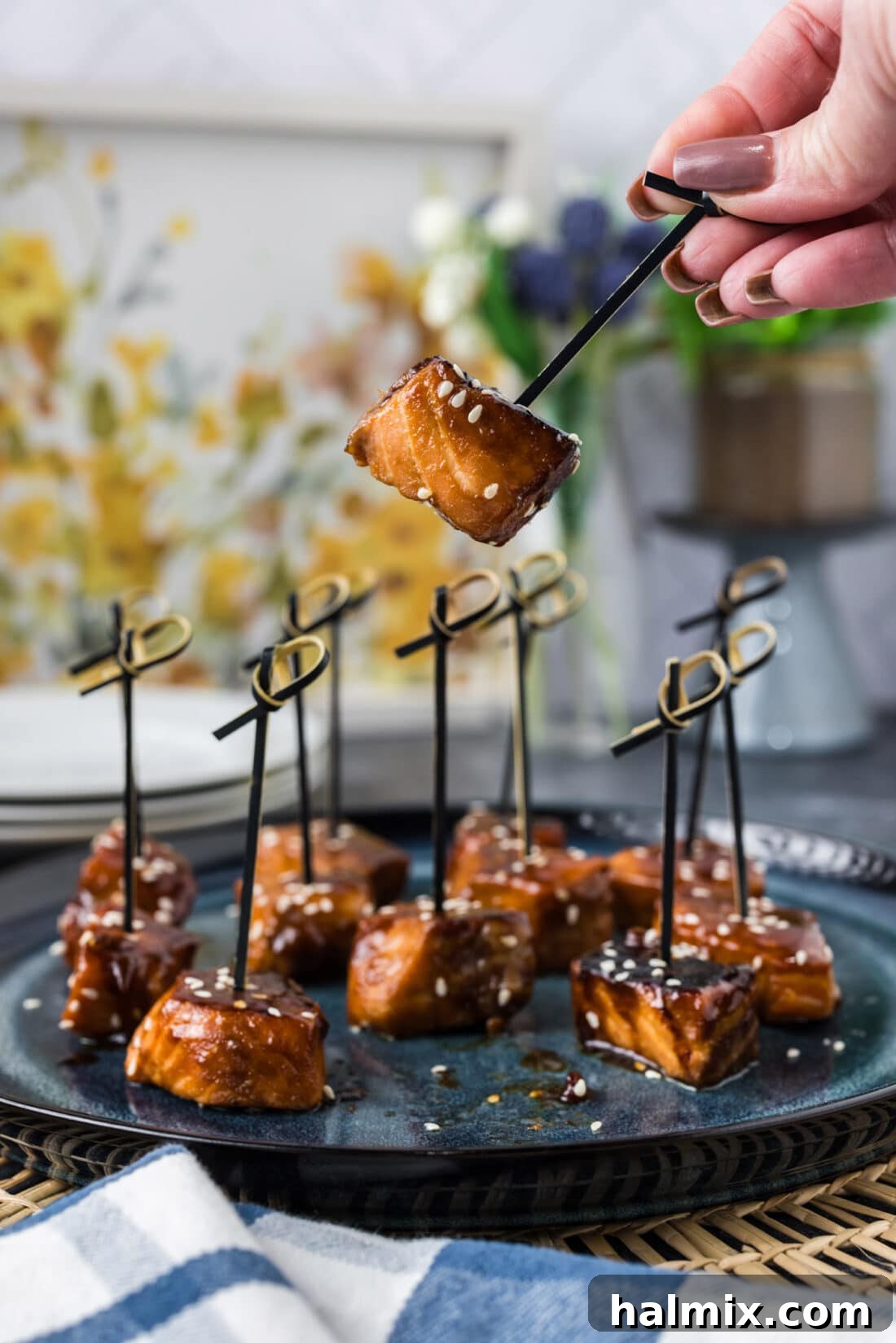 Hand holding up a Salmon Bite on a pick