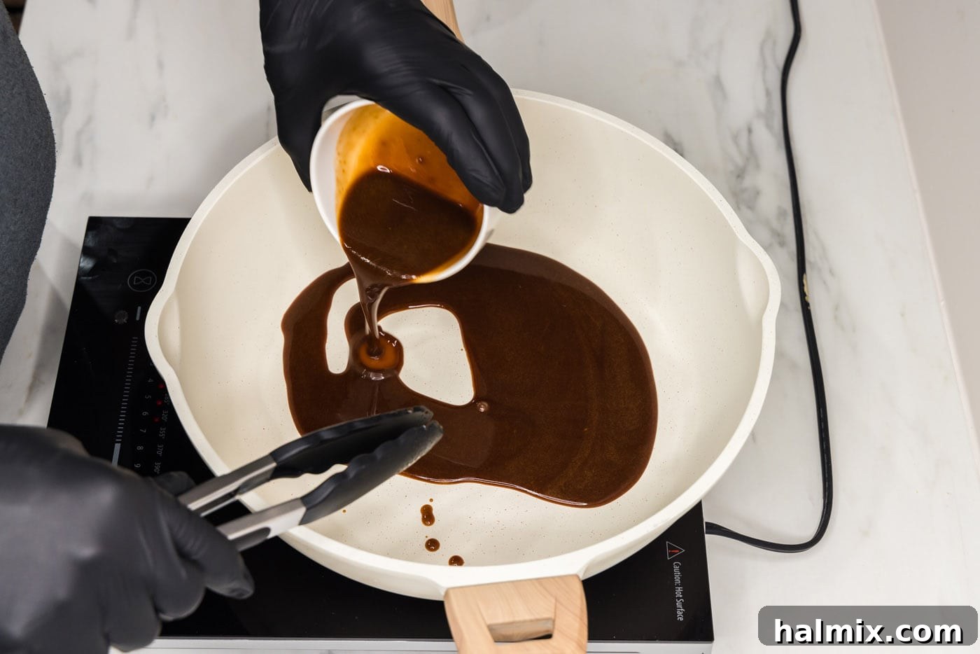 adding salmon marinade to pan