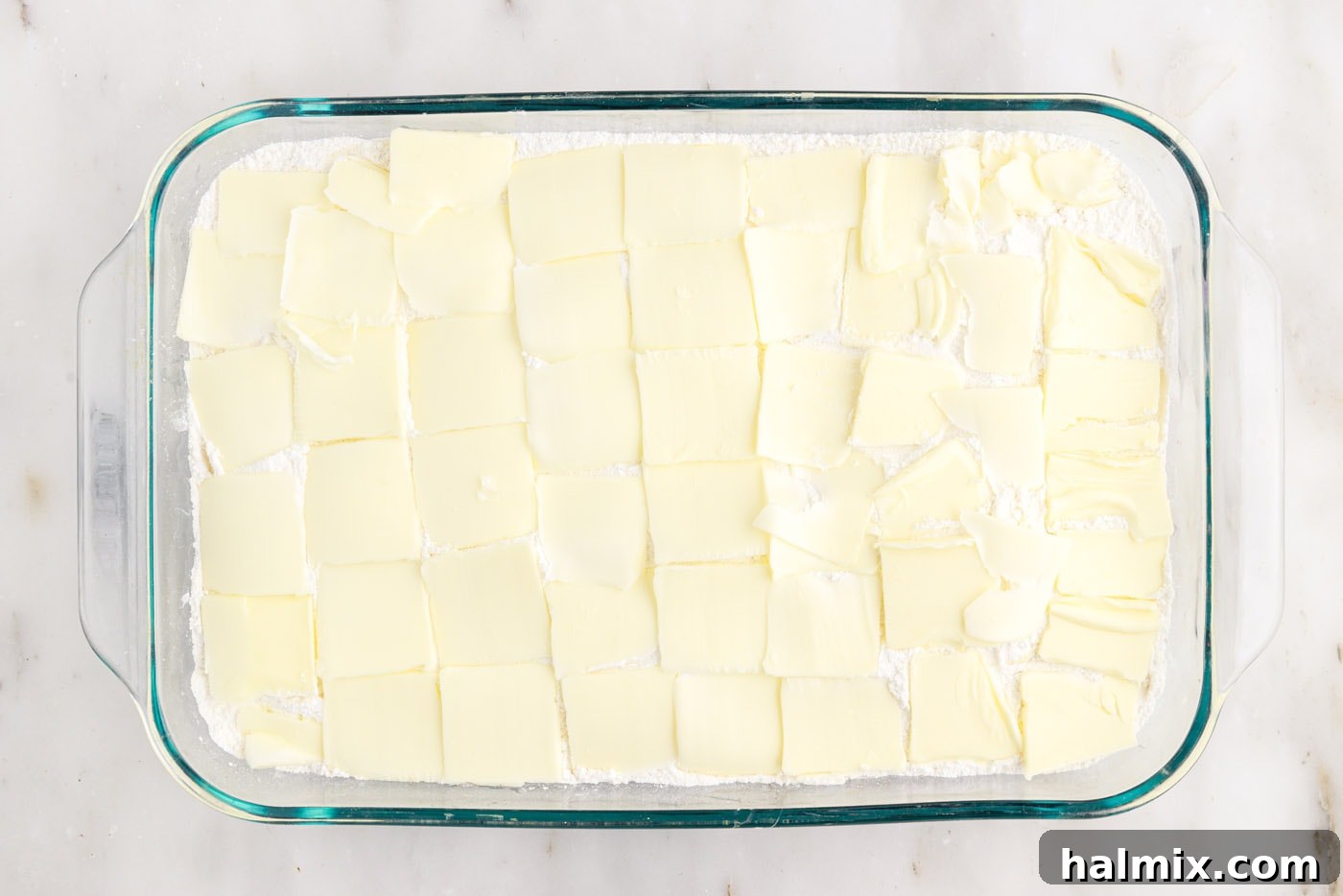 Blueberry Crumble Bake 7 Thin pats of cold butter arranged evenly over the dry cake mix layer in the baking dish