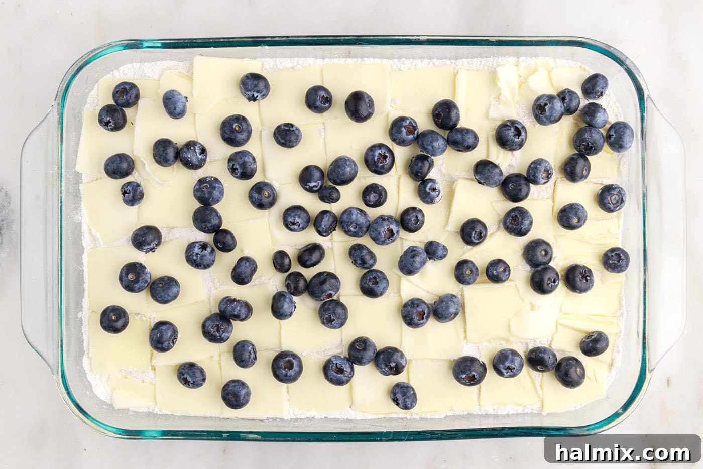 Blueberry Crumble Bake 8 Fresh blueberries speckled over the butter and dry cake mix in the baking dish