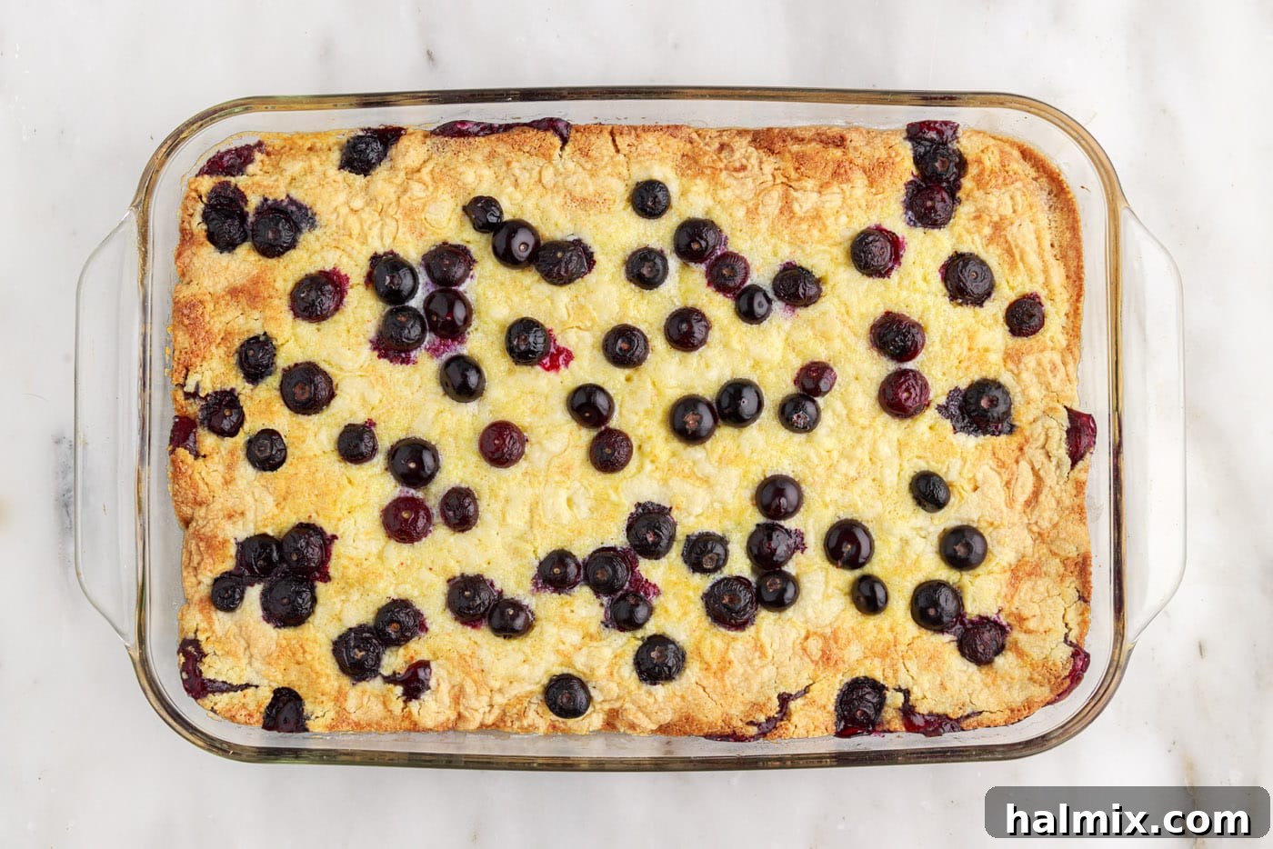 Blueberry Crumble Bake 9 Overhead view of a freshly baked blueberry dump cake, golden brown and bubbling around the edges
