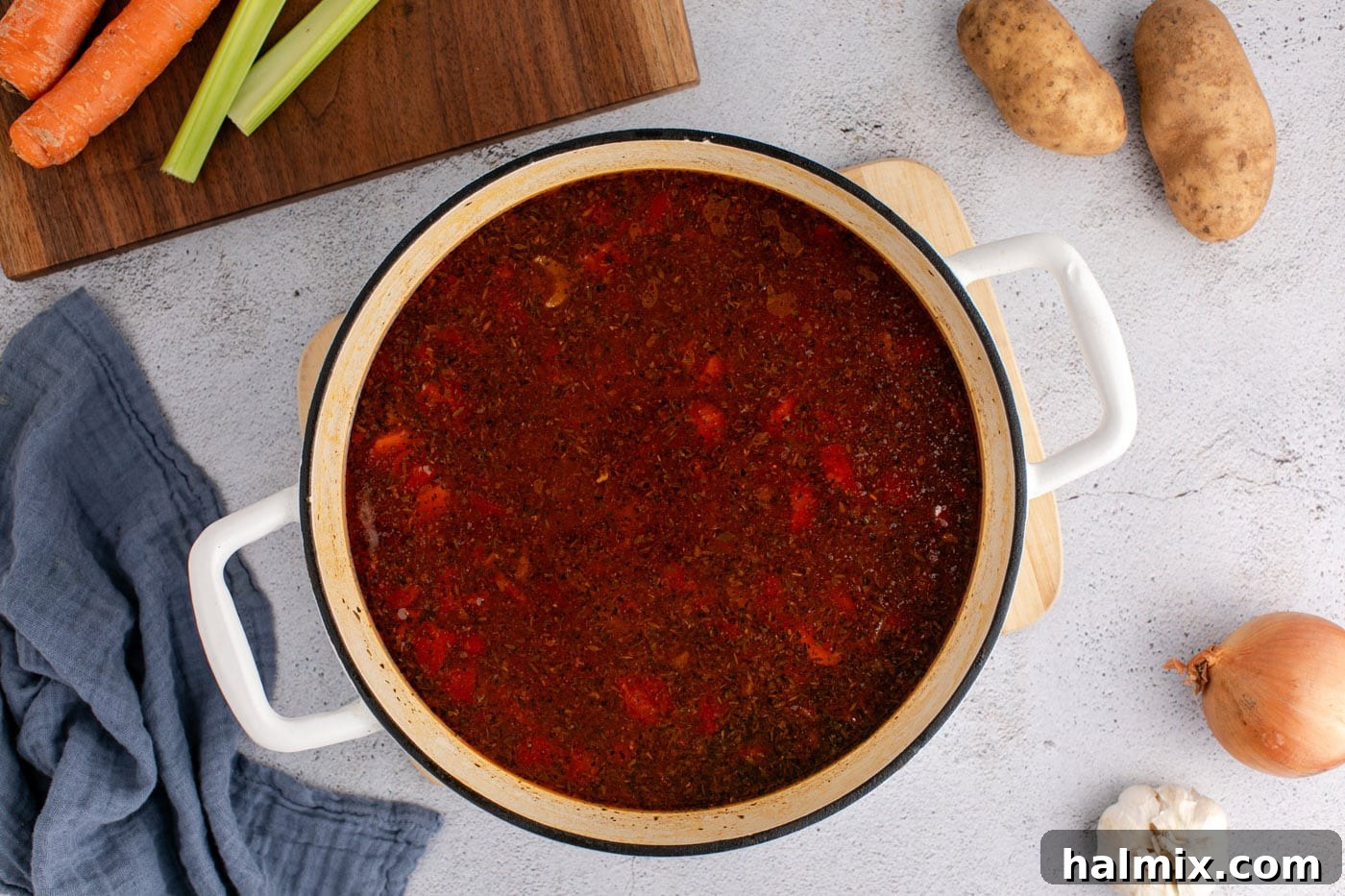 Vegetable beef soup simmering to perfection in a Dutch oven.