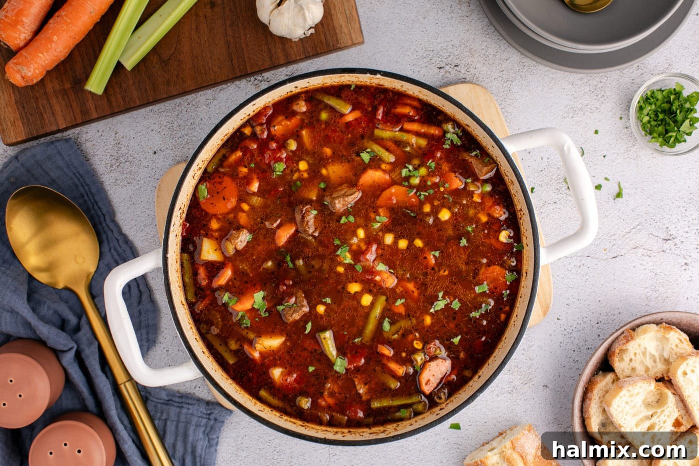 Overhead view of a finished pot of homemade vegetable beef soup, ready to serve.