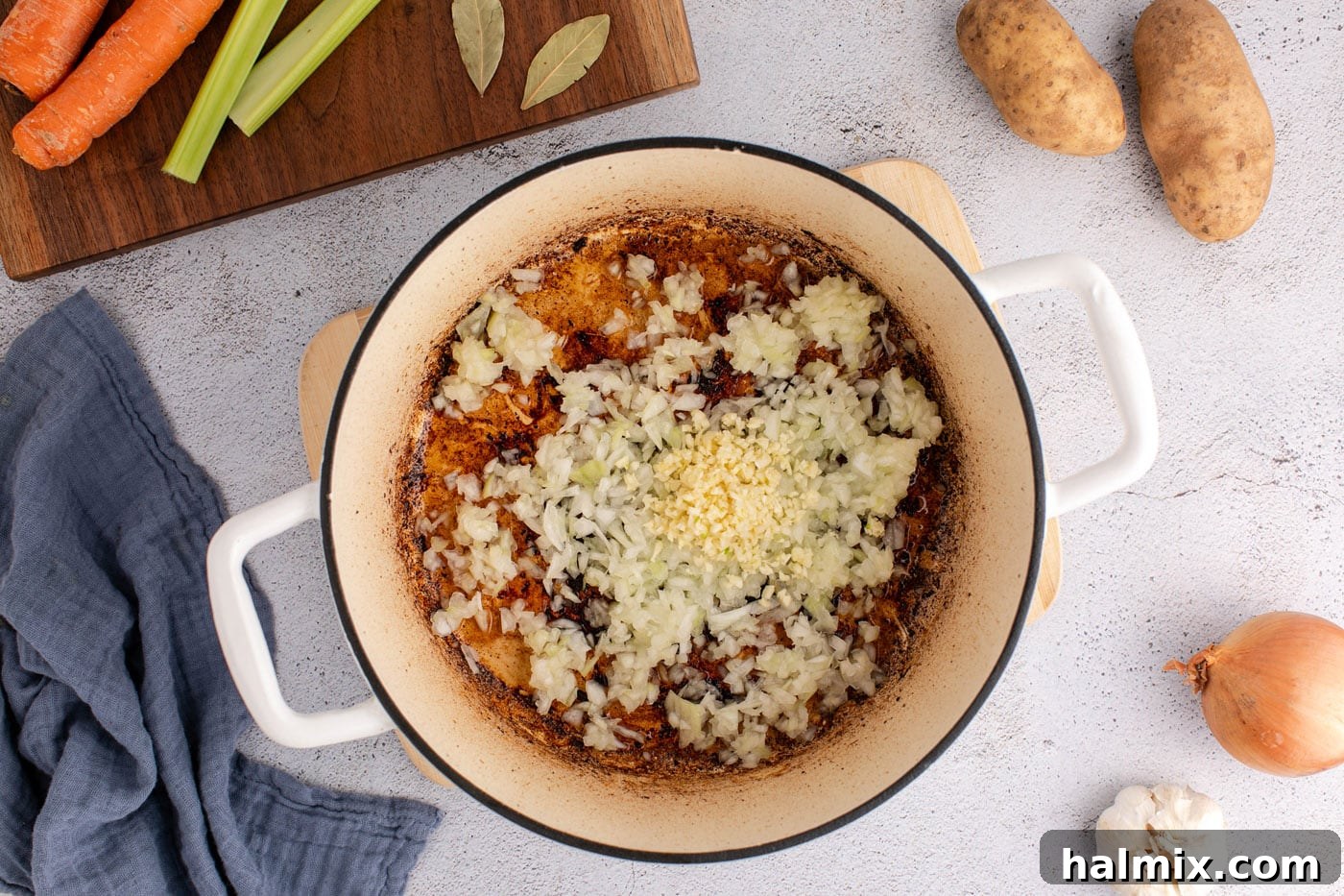 Sautéing onions and garlic in a Dutch oven, building the flavor base for soup.