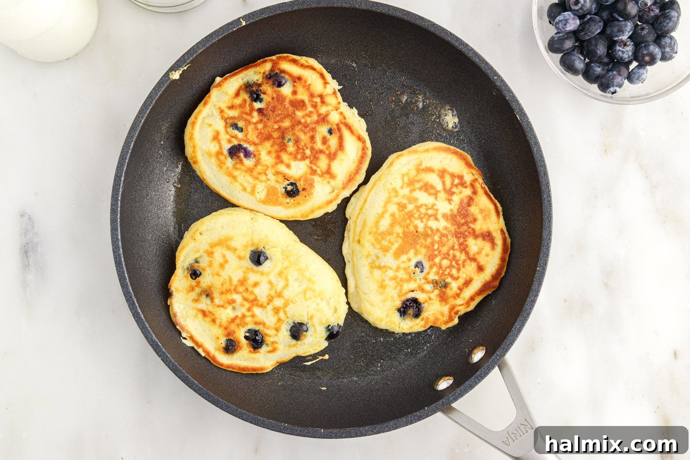 cooked blueberry pancakes in a skillet