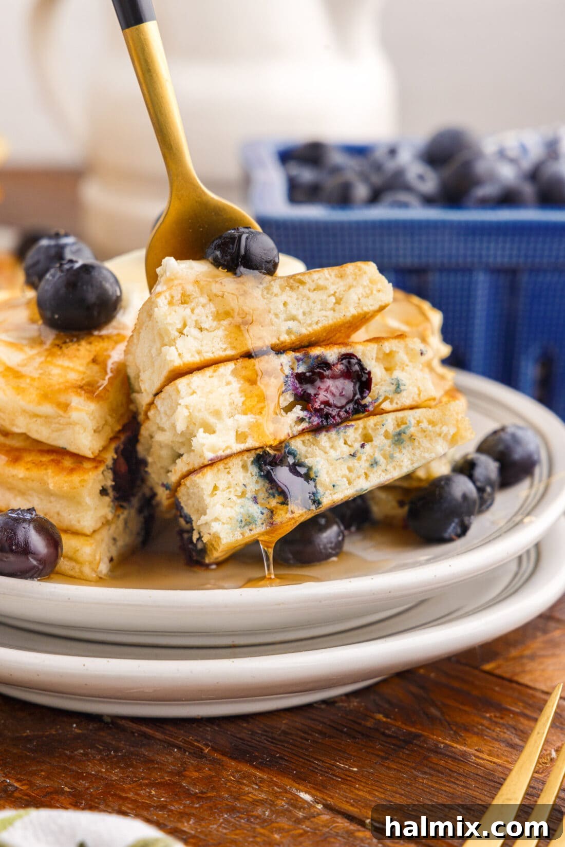 Pieces of Blueberry Pancakes on a fork, highlighting the fluffy texture