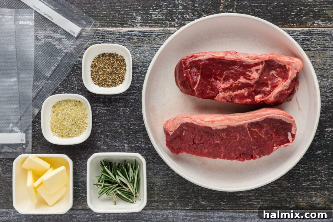 Ingredients for Sous Vide Steak laid out, including raw steaks, butter, rosemary, garlic salt, and pepper