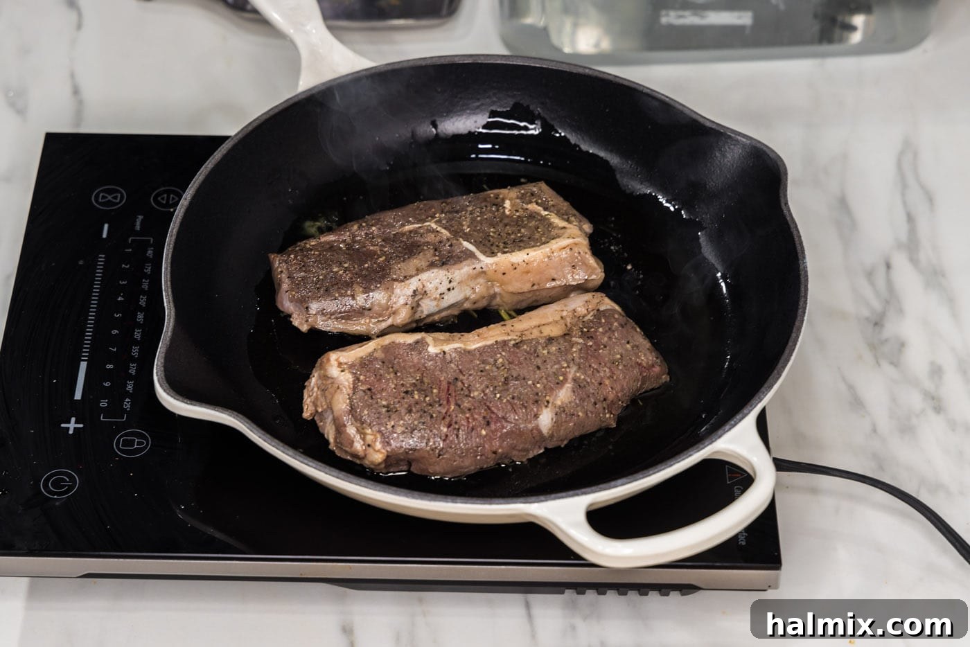 Searing sous vide steaks in a hot skillet to create a crispy crust