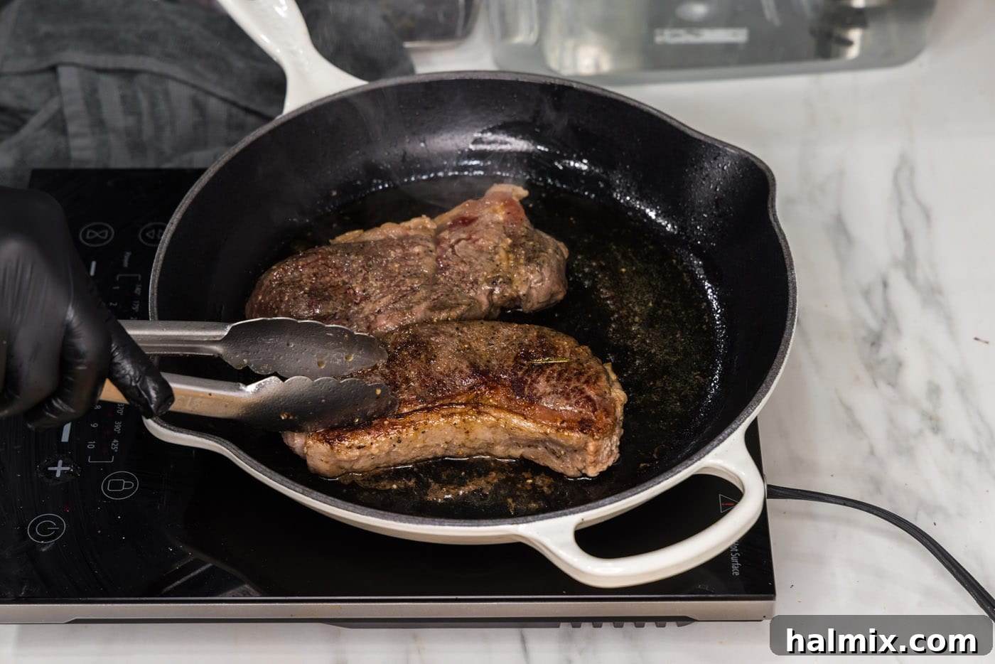 Perfectly seared sous vide New York strip steaks, ready to rest