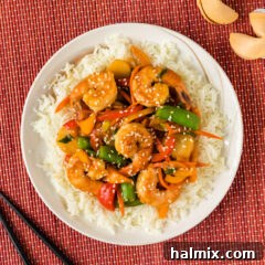 Shrimp Stir Fry over a bed of rice on a plate