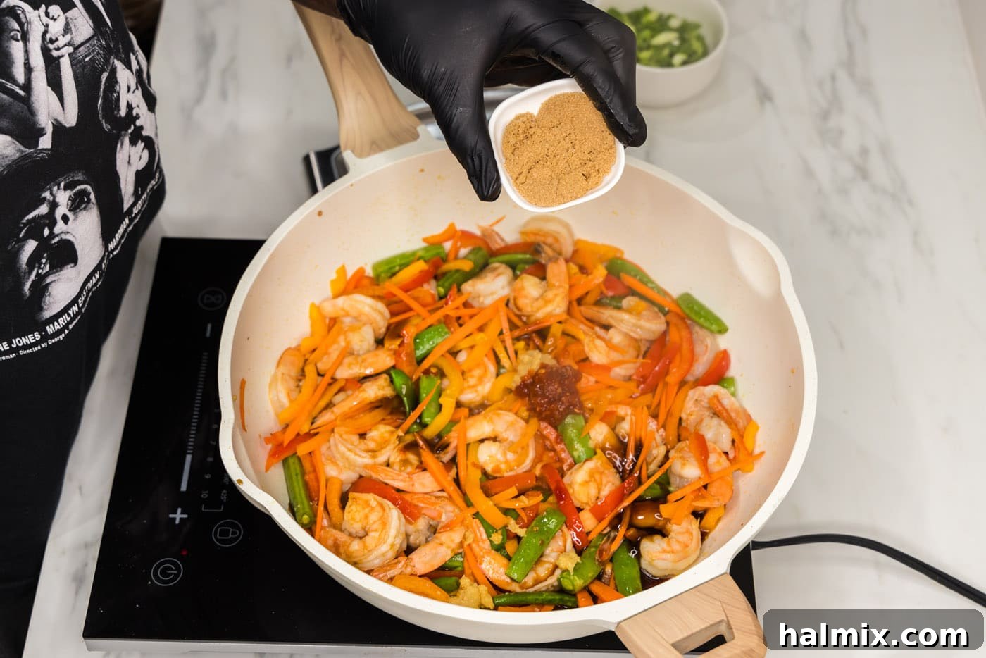 Sweet Chili Shrimp Stir-Fry 8 adding brown sugar to shrimp stir fry in a skillet