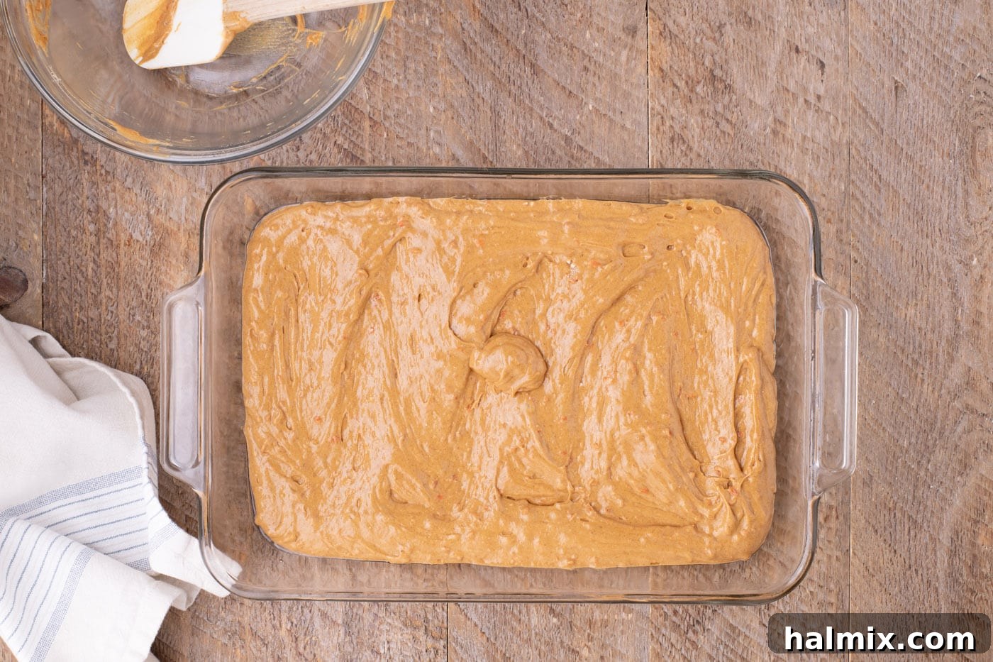 Carrot cake batter poured into a baking dish, ready for the oven