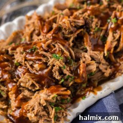 Close up photo of Pulled Pork with barbecue sauce drizzled on top