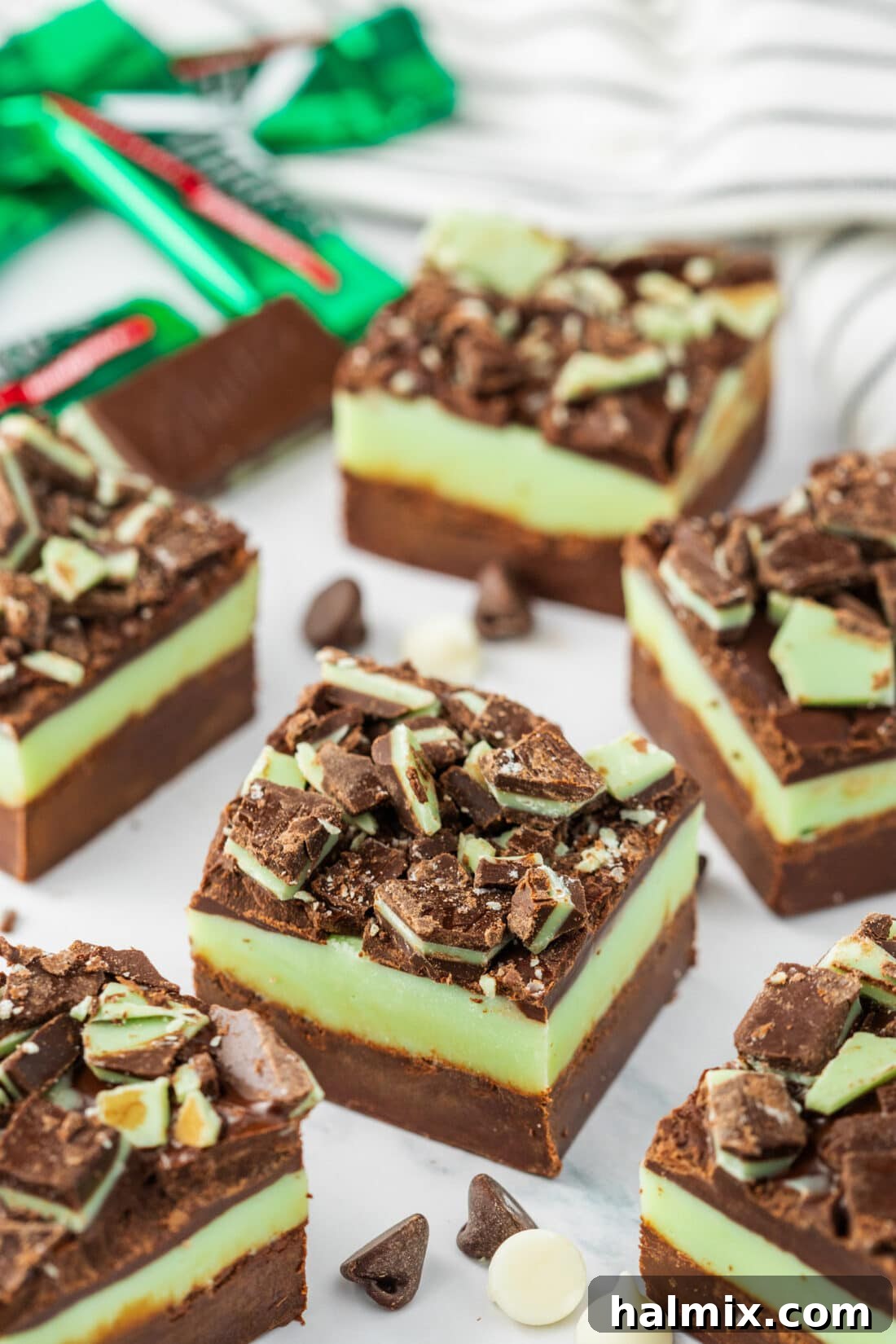 Andes Mint Fudge on a table with mints in the background