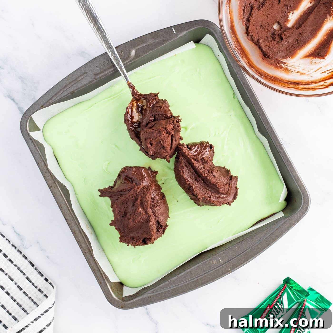 spreading chocolate layer over mint fudge