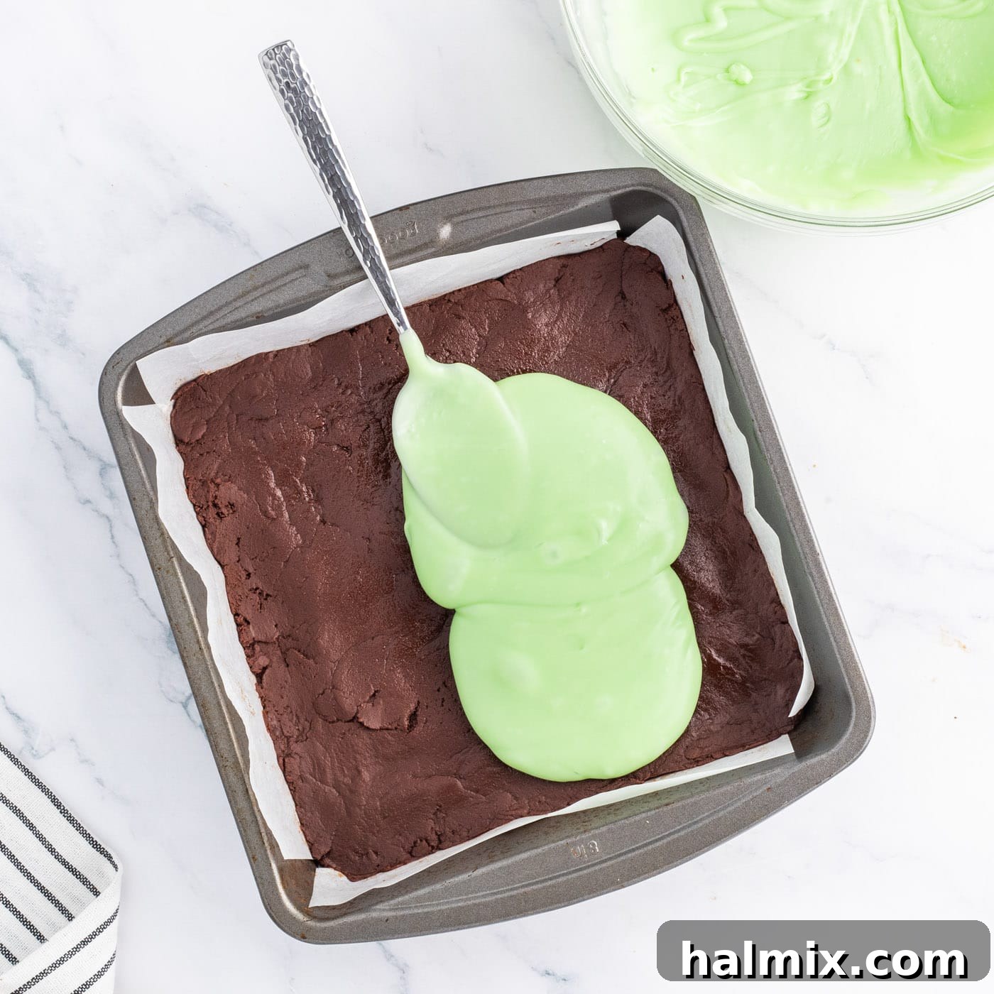 spread mint fudge mixture over chocolate fudge