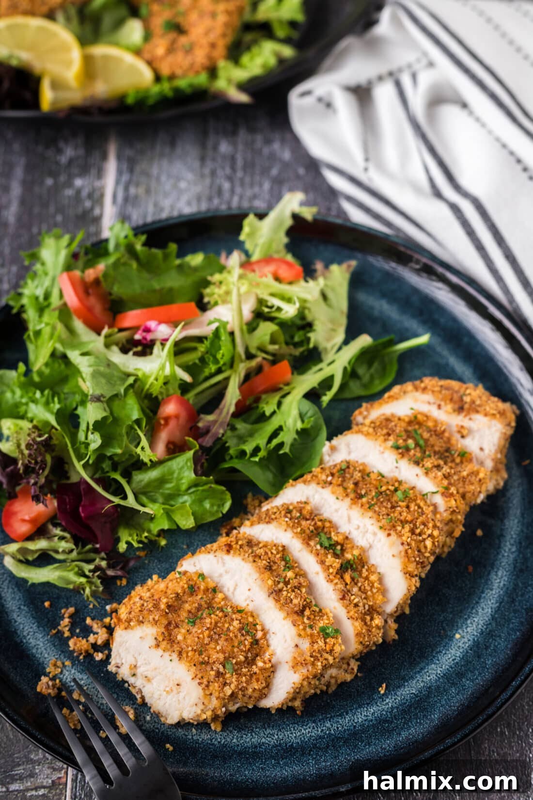 Almond Crusted Chicken on a plate cut into slices, showing its crispy exterior and tender interior.