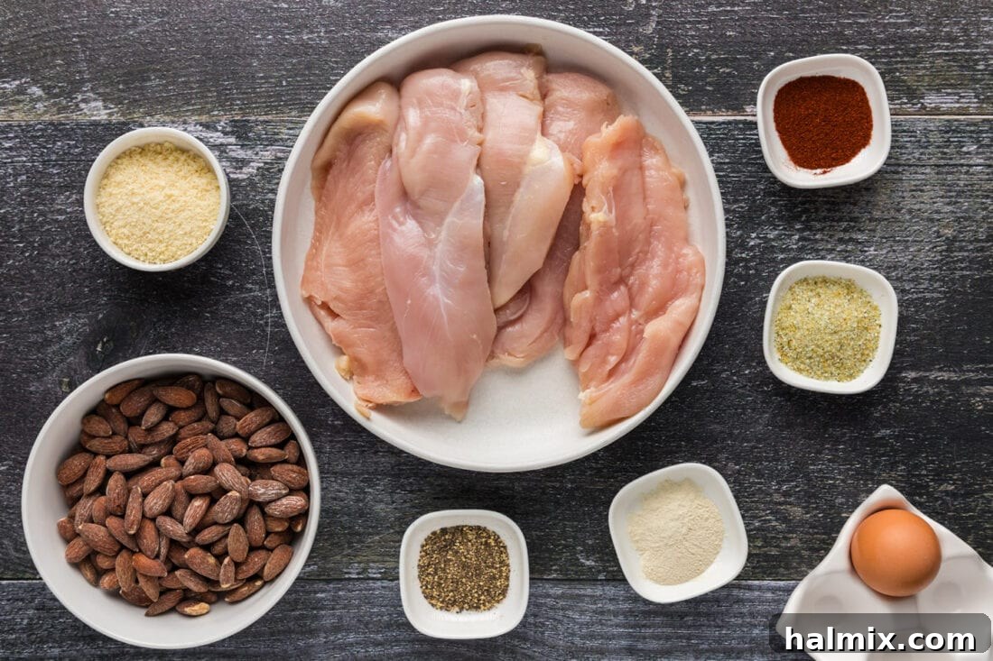 A flat lay photograph showing all the fresh ingredients neatly arranged for making Almond Crusted Chicken.
