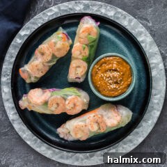 Plate of Shrimp Spring Rolls, beautifully arranged, showcasing their fresh and vibrant fillings.