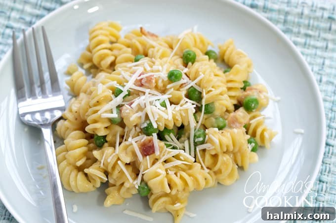 A close-up of a plate with Rotini with Peas and Cheese, ready to be enjoyed as a meal.