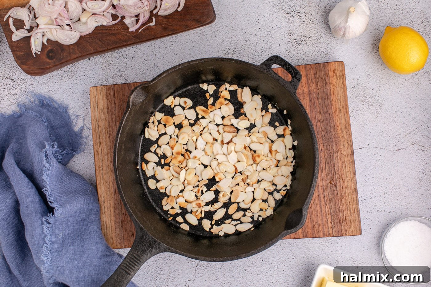toasting sliced almonds in a skillet