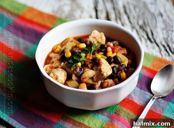 Hearty Chicken Chili with Black Beans and Sweet Corn 12 A beautifully presented bowl of chicken chili, rich with black beans and corn, garnished and ready to be enjoyed.