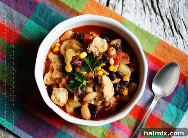 Hearty Chicken Chili with Black Beans and Sweet Corn 4 An inviting overhead shot of chicken chili, brimming with black beans and corn, served in a rustic bowl.