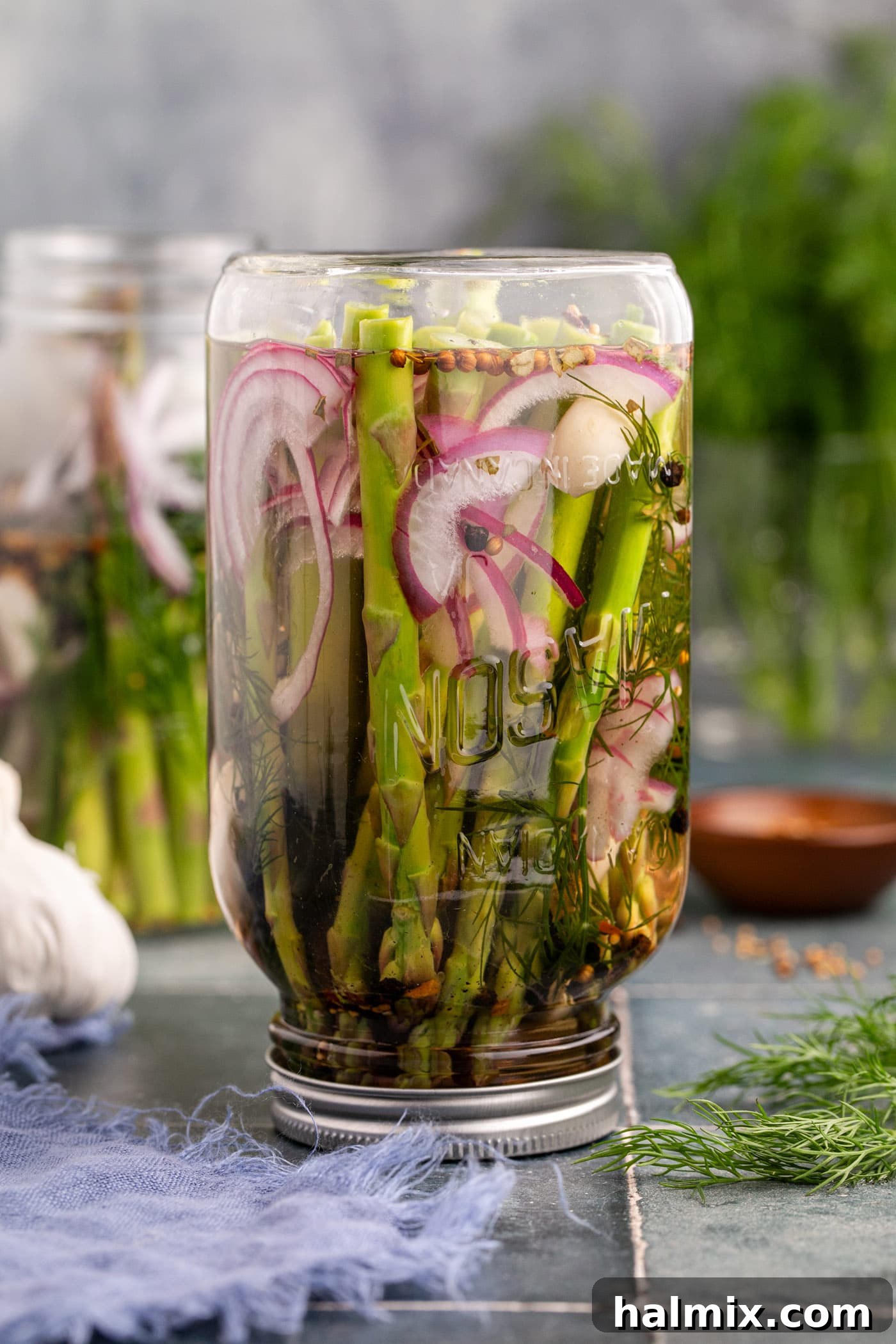 pickled asparagus upside down in a mason jar