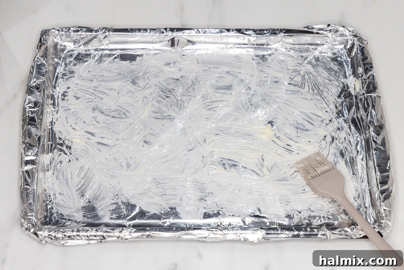 Golden Broiled Scallops 5 Brushing aluminum foil with softened butter before placing scallops.