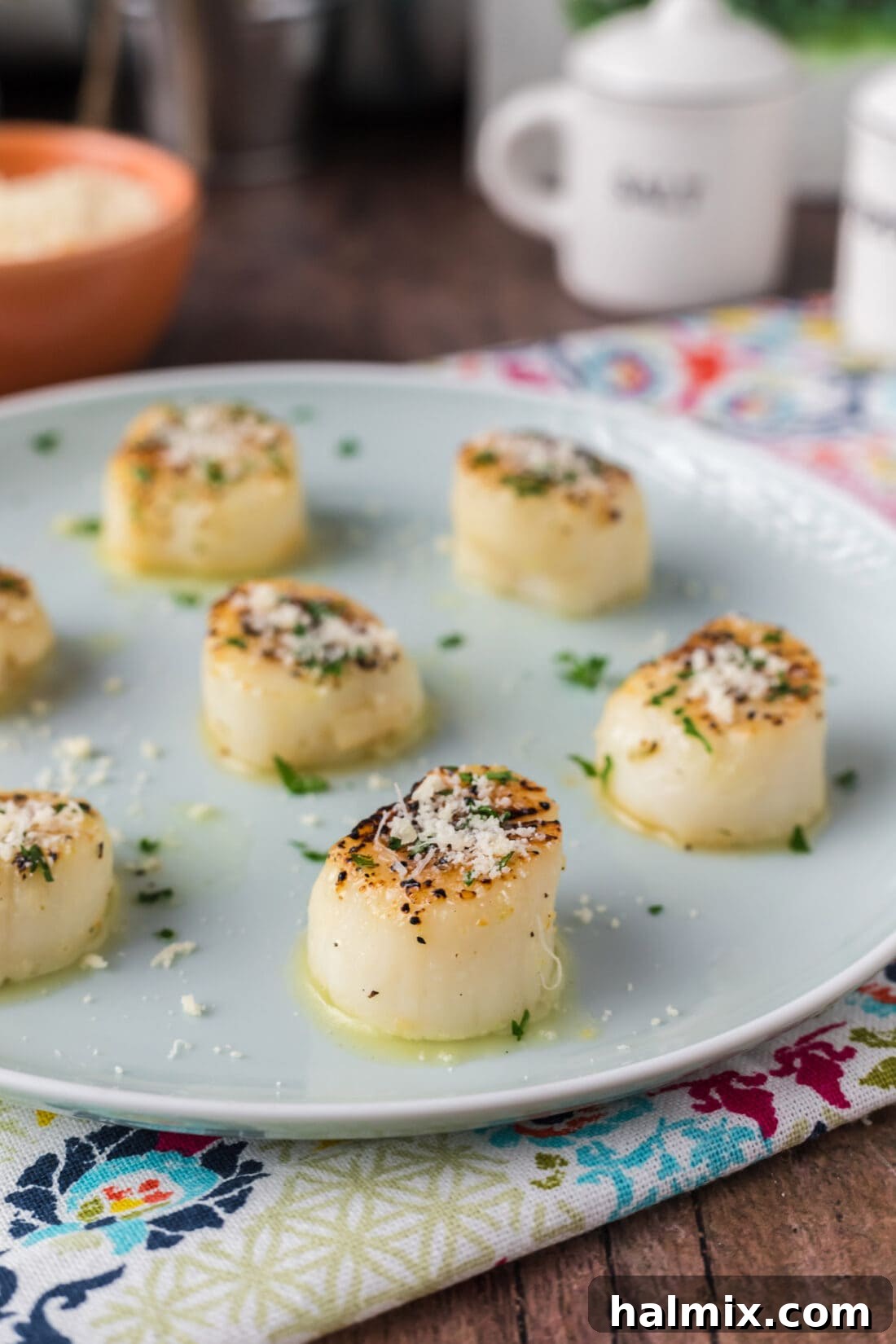 Golden Broiled Scallops 9 Side photo of Broiled Scallops on a plate, garnished with fresh parsley.