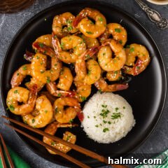 Honey Garlic Shrimp on a plate with rice and chopsticks
