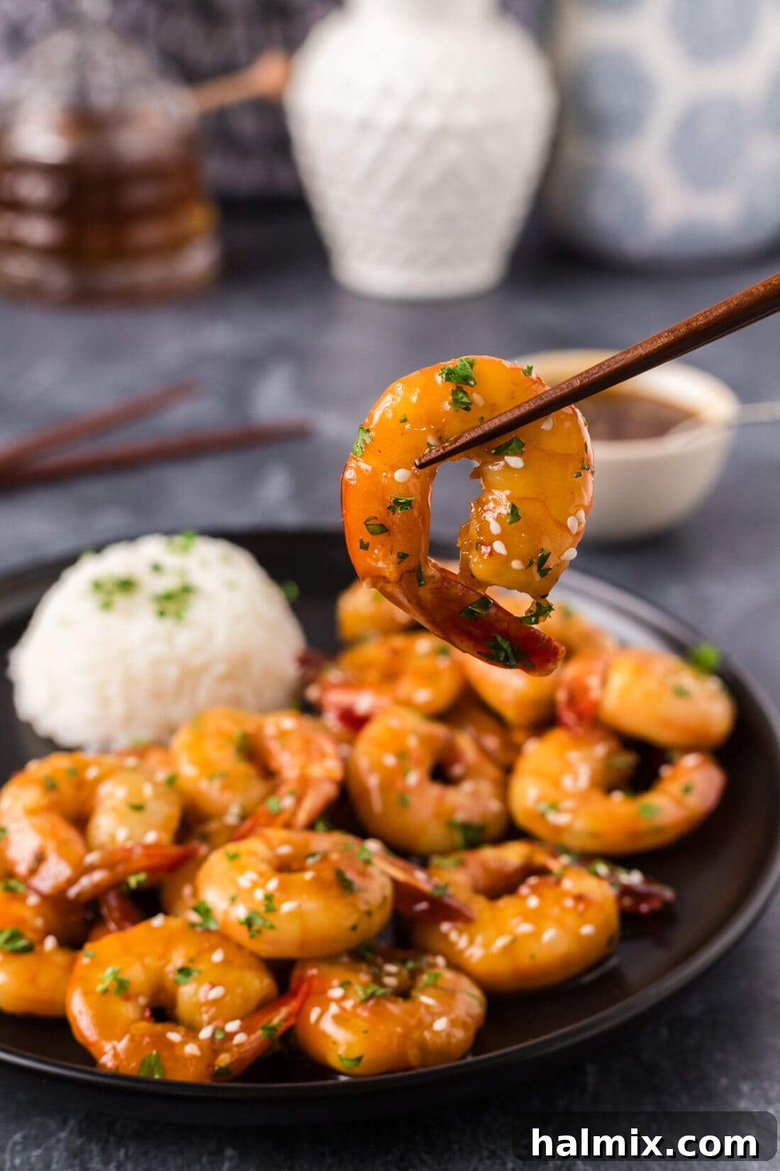 Golden Honey Garlic Shrimp 3 Honey Garlic Shrimp held up by chopsticks, showcasing the sticky glaze