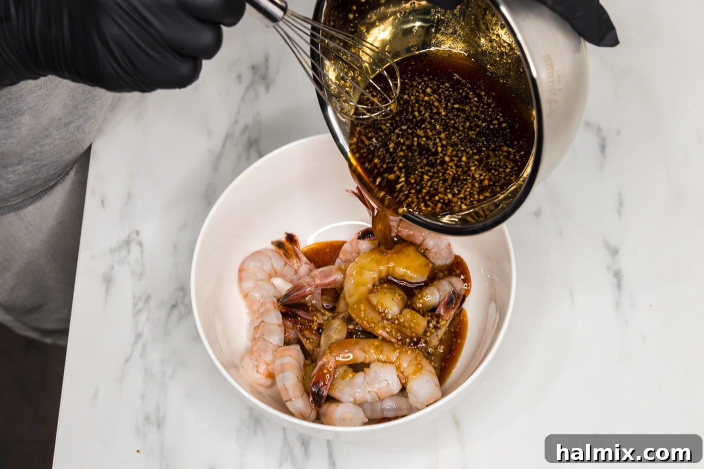 Golden Honey Garlic Shrimp 6 pouring honey garlic sauce over shrimp in a bowl