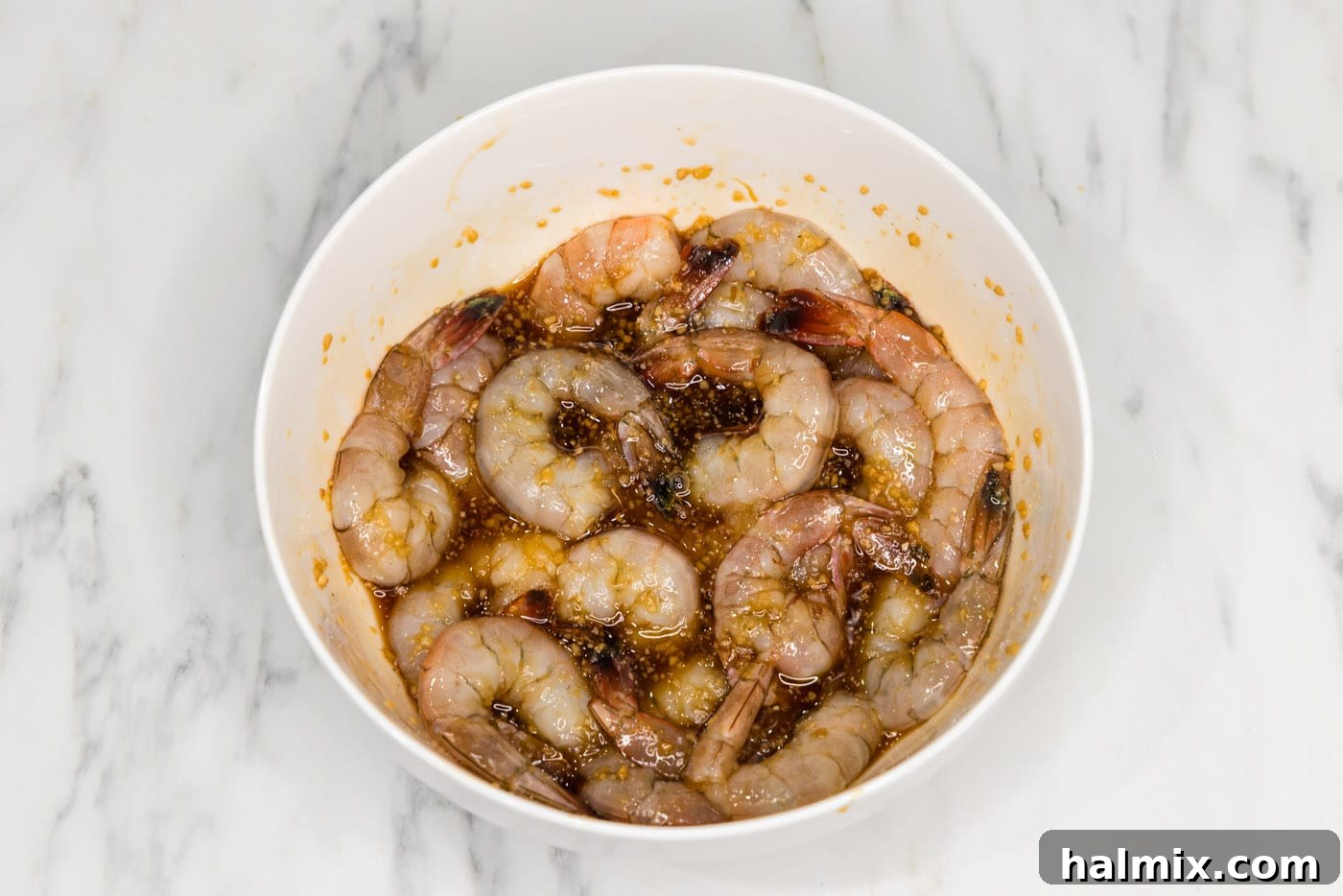 Golden Honey Garlic Shrimp 7 honey garlic shrimp in a bowl, thoroughly coated in sauce