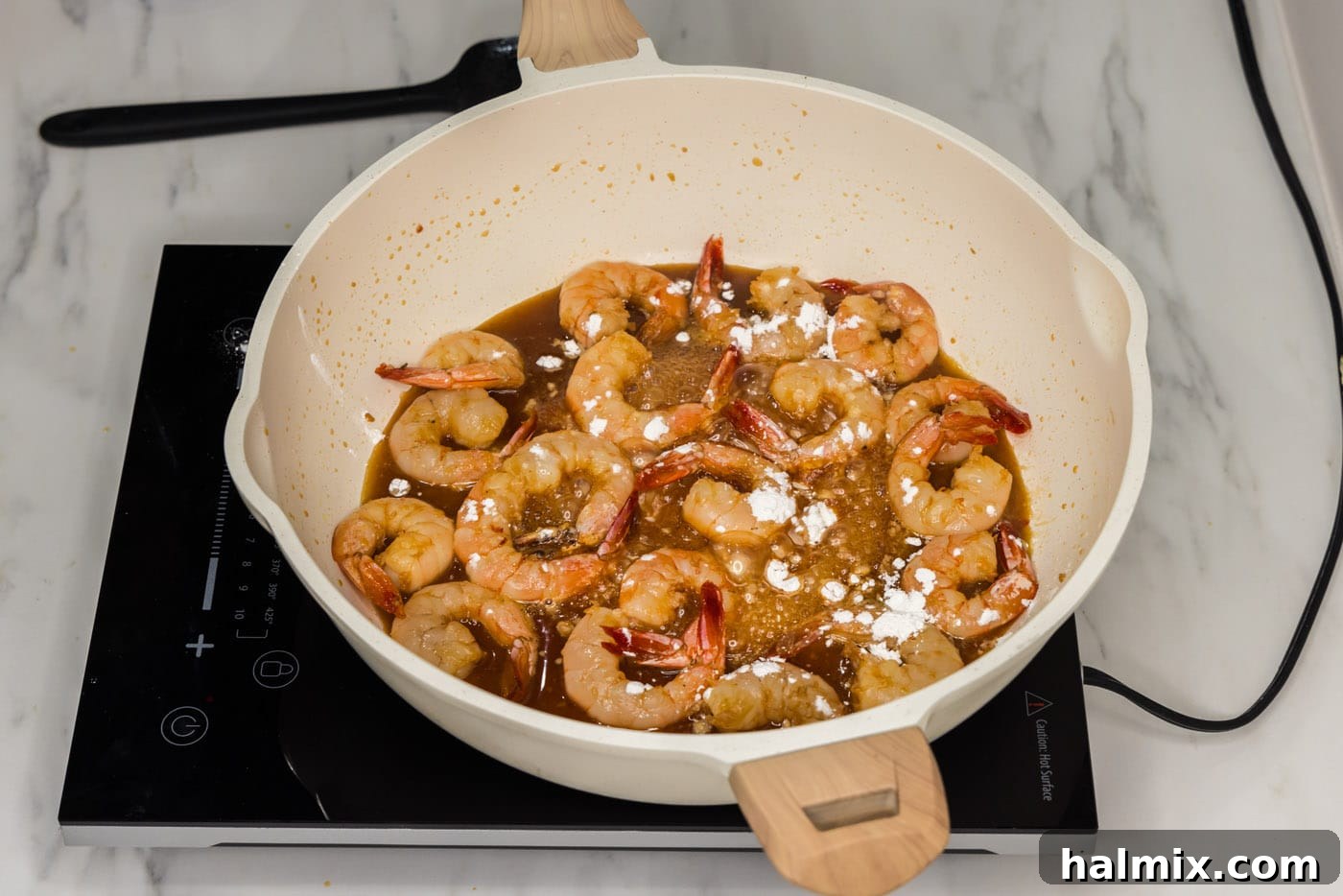 Golden Honey Garlic Shrimp 9 cornstarch sprinkled over honey garlic shrimp in a skillet to thicken the sauce