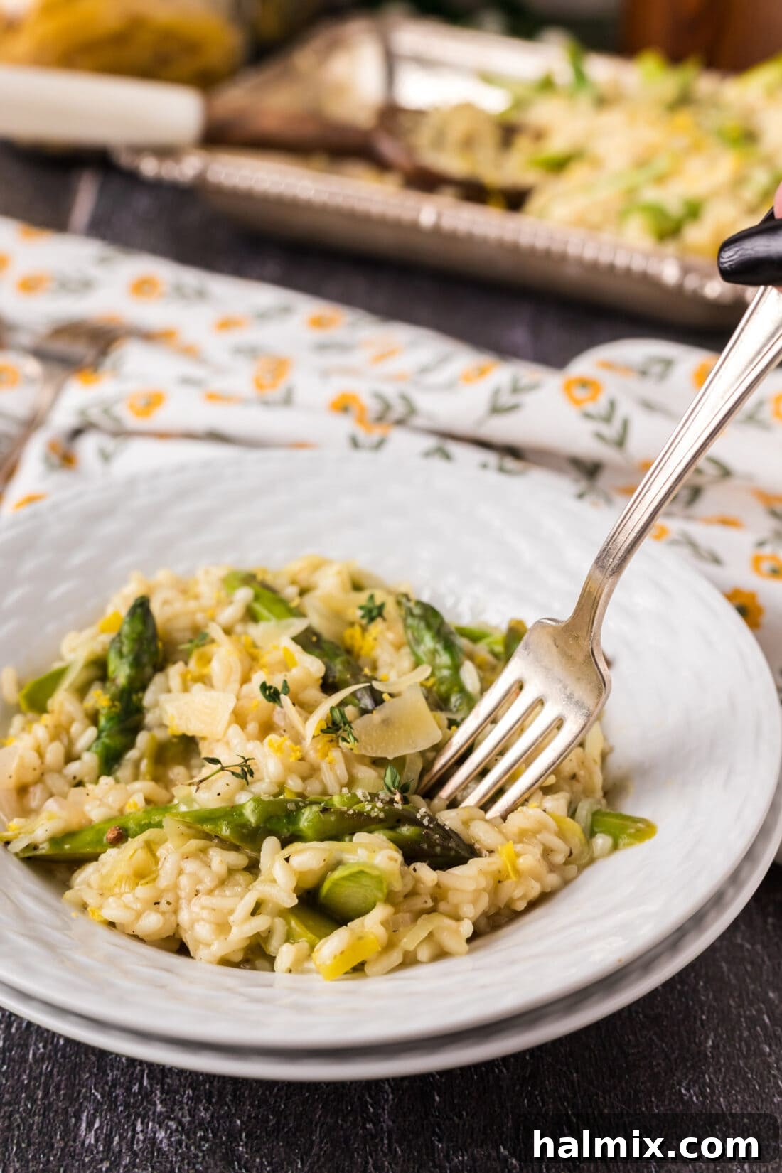 Verdant Asparagus Risotto 2 Fork in a bowl of Asparagus Risotto, showcasing its creamy texture and fresh ingredients